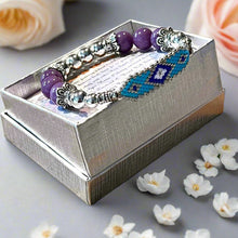 Load image into Gallery viewer,  beaded bracelets on a white card inside a gray box on a wooden surface