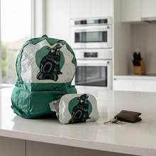 Load image into Gallery viewer, Green and white backpack with a black and blue design on a white background