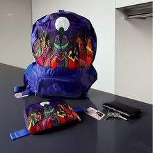 Load image into Gallery viewer, Colorful backpack and pouch with artistic design on a reflective surface.