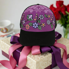 Load image into Gallery viewer, An adjustable cap with a floral pattern on the front panel, featuring purple, green, white, and yellow colors, with a solid black back.