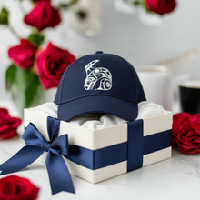 Load image into Gallery viewer, A navy blue adjustable cap featuring a white Orca (killer whale) pattern on the front, displayed with red roses in the background.