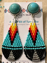 Load image into Gallery viewer, Pair of beaded earrings on a display card with colorful beads in the background.