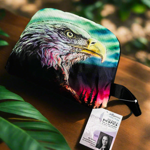 Colorful backpack with an eagle design on a brown surface