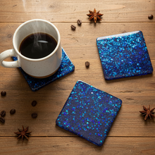 Load image into Gallery viewer, White mug with coffee on blue glittery coasters on a wooden surface with star anise.