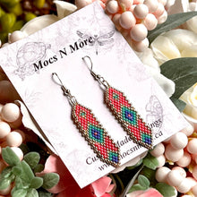 Load image into Gallery viewer, Colorful beaded earrings on a Mocs N More card with flowers and pearls in the background
