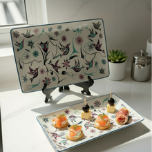Load image into Gallery viewer, Decorative plate with small food items on a white surface with a plant and container in the background.