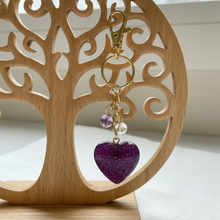 Load image into Gallery viewer, Purple heart-shaped keychain with gold chain and beads in a white box