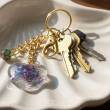 Load image into Gallery viewer, Mocs N More - Glitter Heart Keychain with Purple &amp; Green Glass Bead Charm