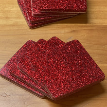 Load image into Gallery viewer, Stack of red glittery coasters on a wooden surface