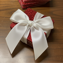 Load image into Gallery viewer, Stack of red glittery cards with a white bow on a wooden surface.