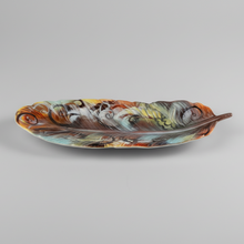 Load image into Gallery viewer, Decorative ceramic feather shaped plate with multicolored design on a gray background