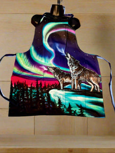 Apron with a wolf and Northern Lights design on a textured surface