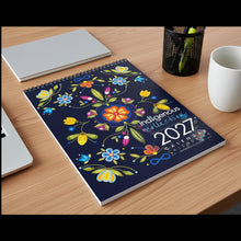 Load image into Gallery viewer, 2027 calendar with colorful indigenous design on a gray floor