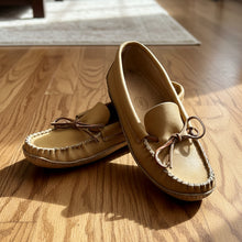 Load image into Gallery viewer, Pair of tan moccasin shoes with decorative laces on a neutral background