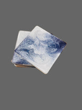 Load image into Gallery viewer, Marble-patterned coasters on a wooden surface