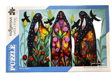 Load image into Gallery viewer, Jigsaw puzzle packaging with 'Three Sisters' artwork by Jackie Traverse on a wooden surface.