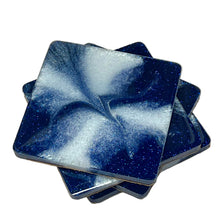 Load image into Gallery viewer, Set of four blue and white marbled coasters on a beige surface