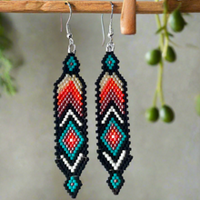 Load image into Gallery viewer, Pair of beaded earrings hanging on a wooden stick with a natural background.