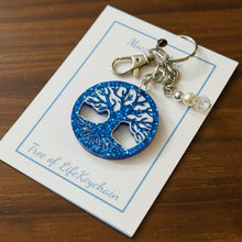 Load image into Gallery viewer, Blue and white tree of life keychain on a card with 'Moccasin Creek' branding.