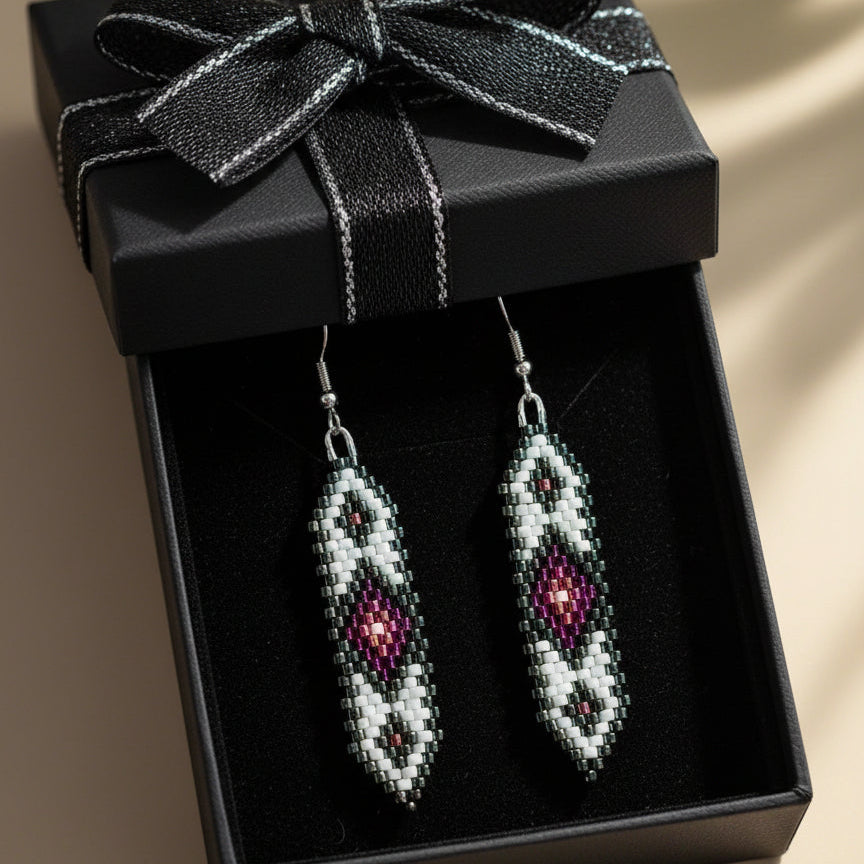 Beaded earrings in a black gift box with a bow
