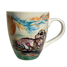 Load image into Gallery viewer, A white ceramic coffee mug with a colorful painted design of a blue feather and a sleeping owl, displayed on a white shelf.