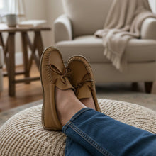 Load image into Gallery viewer, Pair of tan moccasins with brown laces on a light gray surface.