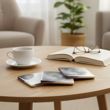 Load image into Gallery viewer, Round wooden coffee table with a cup, books, and glasses in a cozy living room.