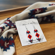 Load image into Gallery viewer, Earrings on a card with a patterned fabric background
