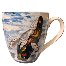 Load image into Gallery viewer, A ceramic coffee mug featuring a painted design of a whale breaching blue water, with a cream-colored handle and rim.
