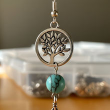 Load image into Gallery viewer, Close-up of tree of life, feather, and howlite