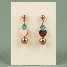 Load image into Gallery viewer, Copper Sweetheart earrings against sage green