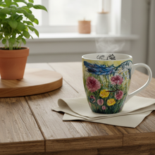 Load image into Gallery viewer, Dreamcatcher mug on a rustic farmhouse kitchen table with linen napkin and potted herb