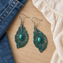 Load image into Gallery viewer, Turquoise Willow Leaf Earrings styled beside denim and a cream blouse