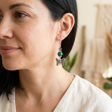 Load image into Gallery viewer, Lifestyle close-up of a woman wearing the green bead and silver butterfly earring