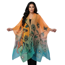 Load image into Gallery viewer, A woman modeling a lightweight sheer poncho-style wrap with a multicolor gradient transitioning from orange at the top to teal at the bottom, decorated with floral and butterfly motifs.
