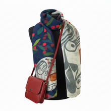 Load image into Gallery viewer, Mannequin wearing a colorful scarf with a red handbag on a white background