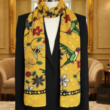 Load image into Gallery viewer, Yellow floral and bird patterned scarf on a mannequin against a decorative interior background.