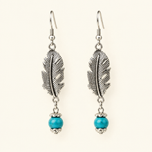 Load image into Gallery viewer, New product shot of silver feather earrings with round blue bead ends