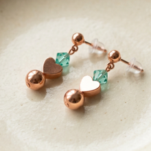 Load image into Gallery viewer, Petite Copper Sweetheart earrings on a cream ceramic dish