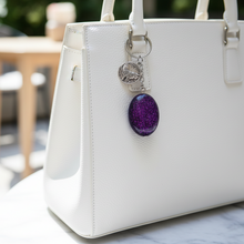 Load image into Gallery viewer, Purple wolf keychain on white purse